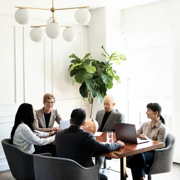 Leadership team meeting around a walnut boardroom table
